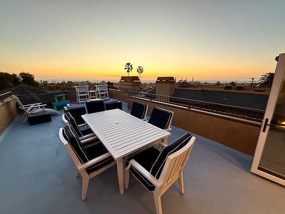 Large deck off the living/dining room with ocean views that stretch from PV to Malibu