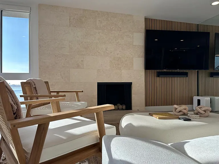 Embrace comfort and entertainment in the living room by the fireplace and TV.