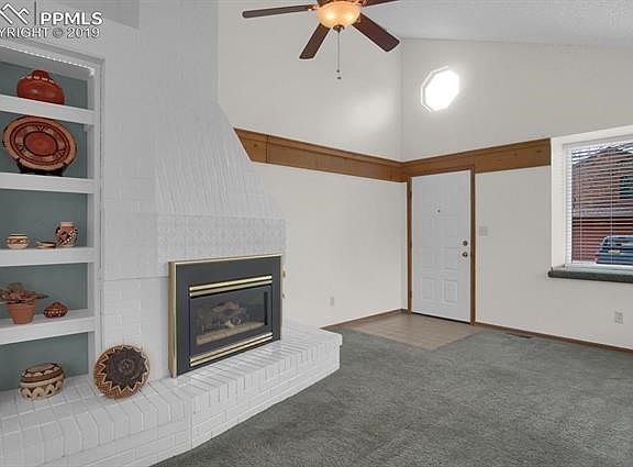 Living room with gas fireplace and tile entry