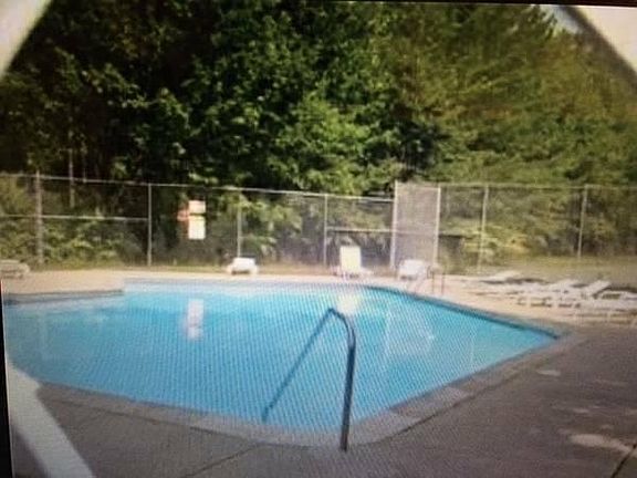 Professionally maintained in-ground pool and lounge area.