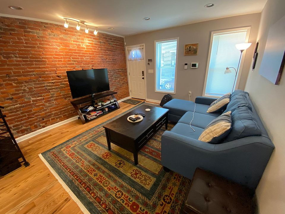 Shared family room with exposed brick