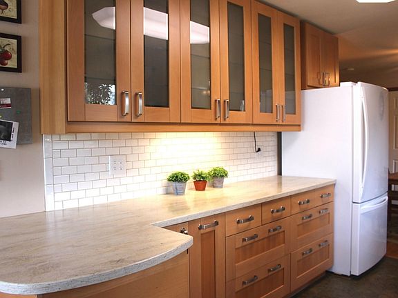 Fantastic Ikea kitchen includes soft close cabinetry, corian countertops, tile backsplash, new flooring, sink, and updated appliances!