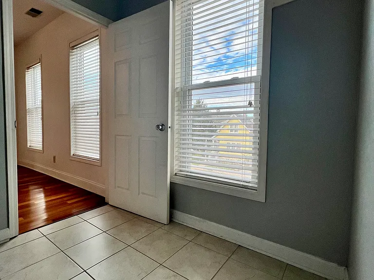 walk in closet for front bedroom, with window.