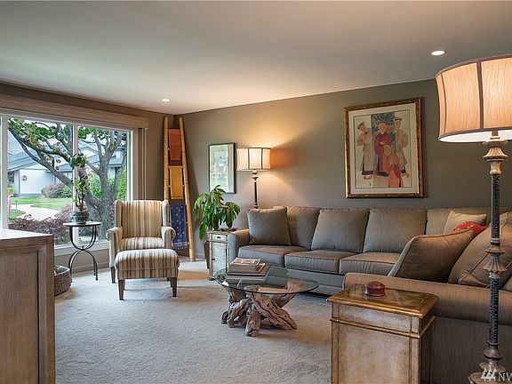 Classy living room with large picture windows looking out to courtyard.