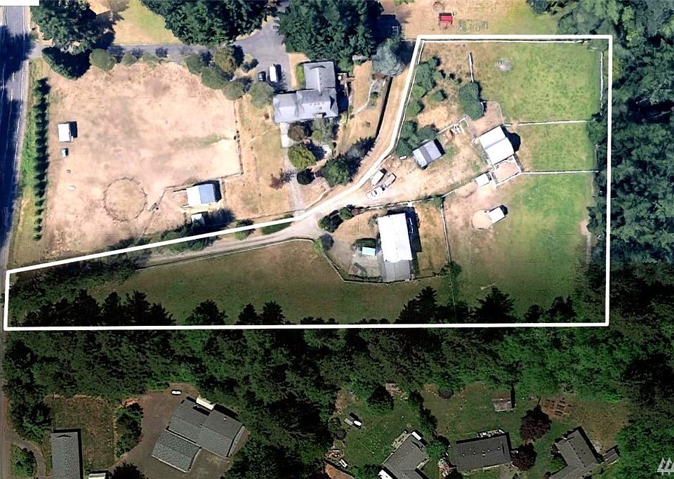 This large, split-level home on over 3 acres has two attached garages and two detached garages - enough covered parking for 6 vehicles.