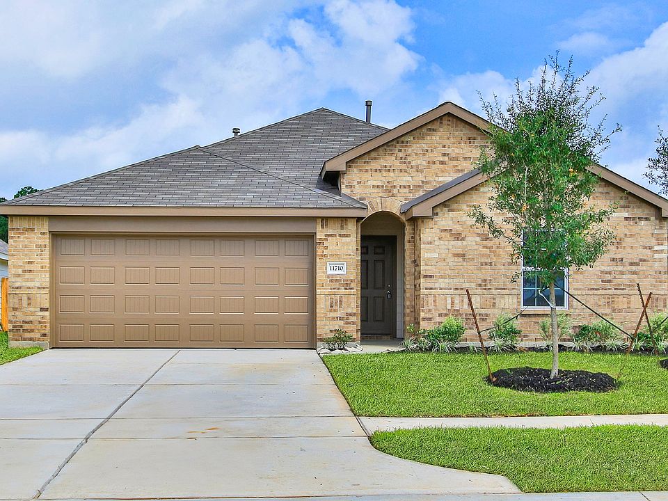 Luxurious brick facade, arched entryway, pristine landscaping in serene Cielo setting.