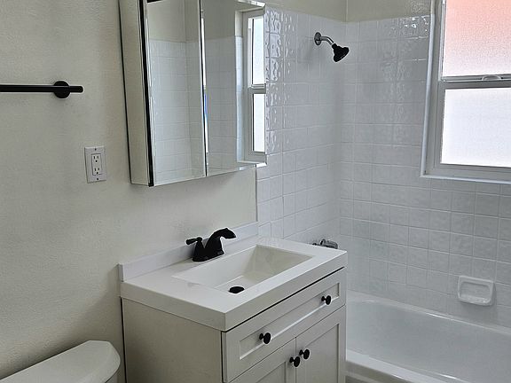 Full restroom with shower and bathtub.