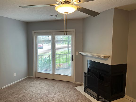Living room with access to screened-in, covered porch