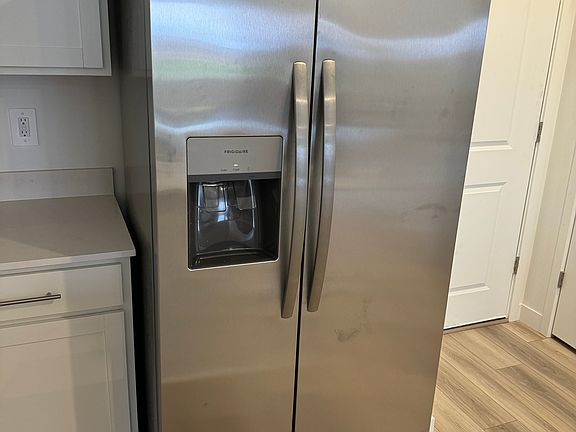Stainless steel fridge with ice and water.