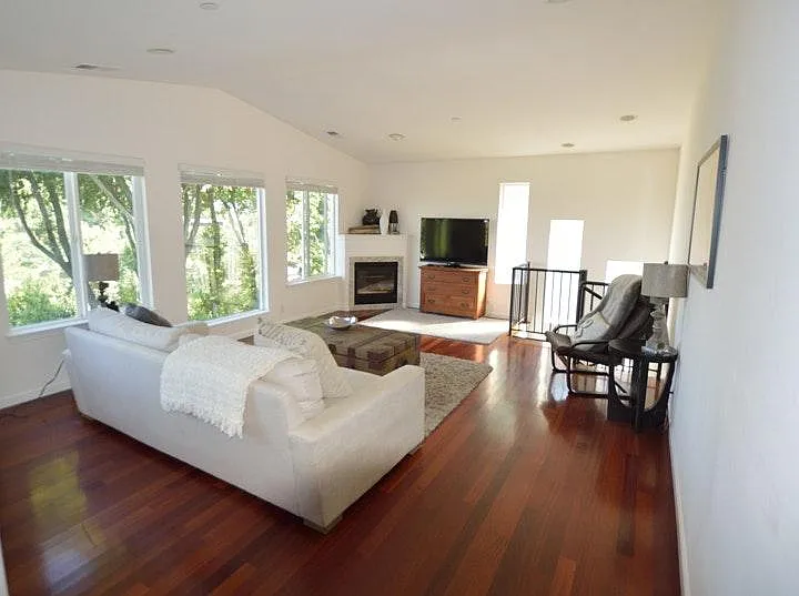 Family room with views over bay and hills. Second fireplace