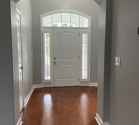 View of front door entryway from living room