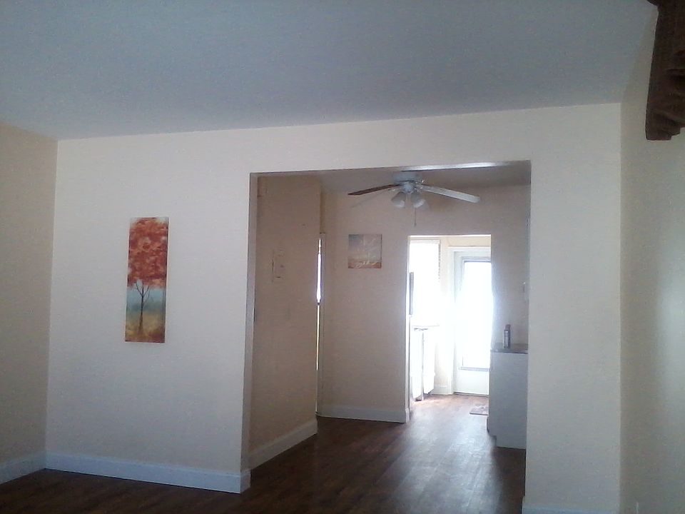 Close-up to view back door exit to small railed balcony that leads to downstairs & laundry room.