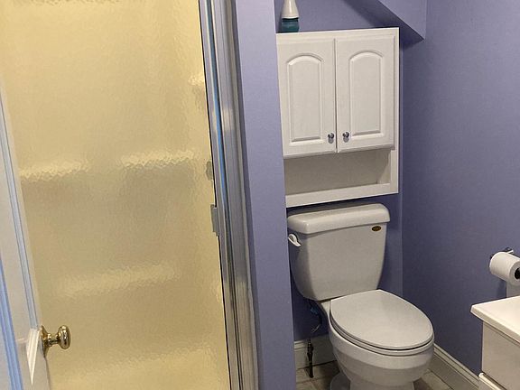 Shower and lots of storage above the toilet and vanity