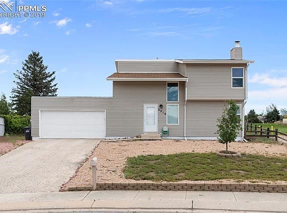 Come on in and see the inside of the cute home! Add some flowers , shrubs, maybe flower boxes and this home will look so invitin