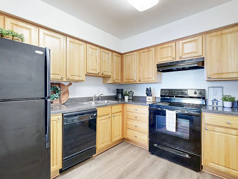 Kitchen with granite counters and black appliance package
