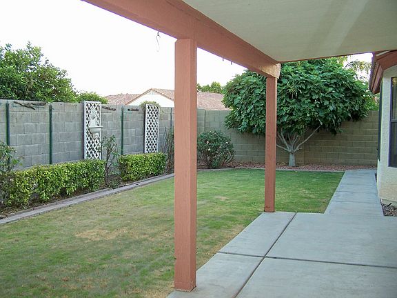 Covered patio, grassy, fenced backyard