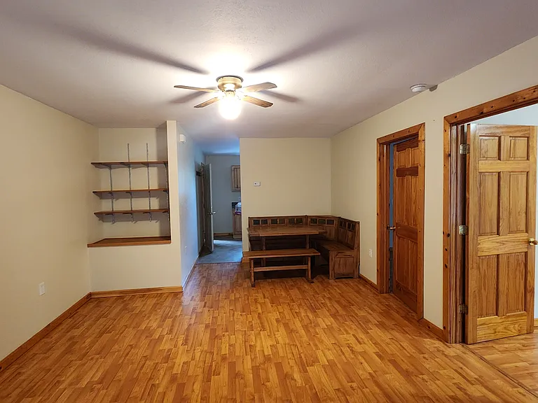 Living room/dining area showing entrances to kitchen and bedrooms