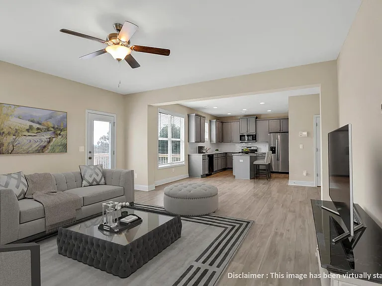 Living room with large window letting in a ton of natural light.