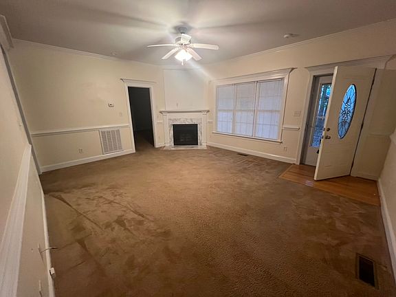 Living room with gas log fireplace and TV nook.