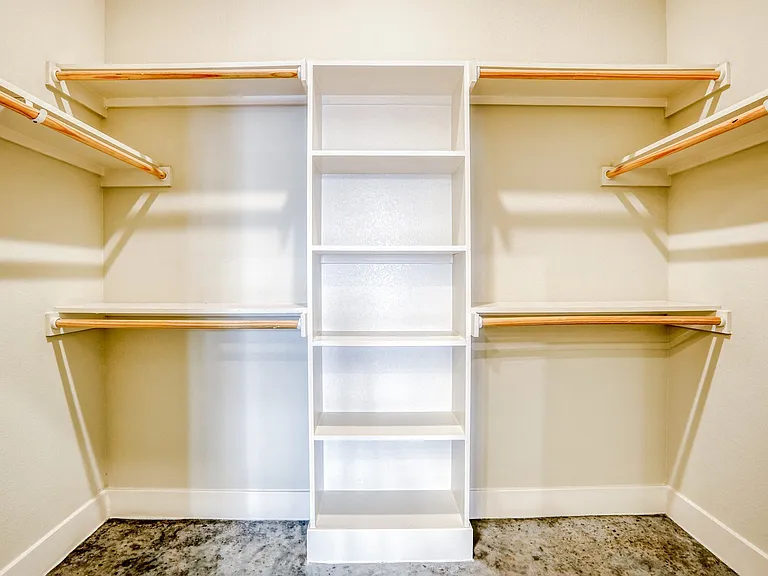 Spacious walk in closets with built in shelving
