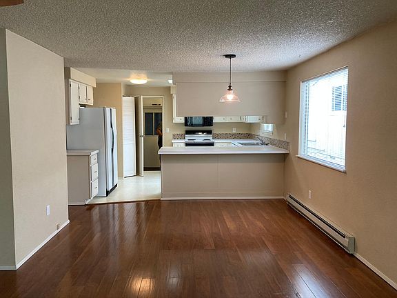 Standing at deck, looking at living room, kitchen ending at garage.