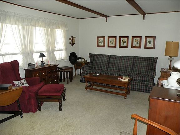 Living Room open to Dining Room w/Beamed Ceiling & Hardwood under w/w Carpet