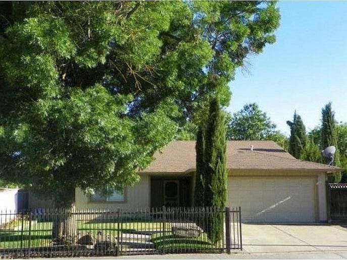 Fenced yard with large garage