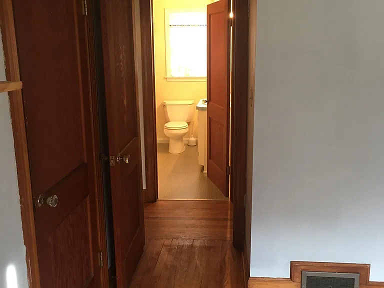 from bedroom looking through hallway to bathroom