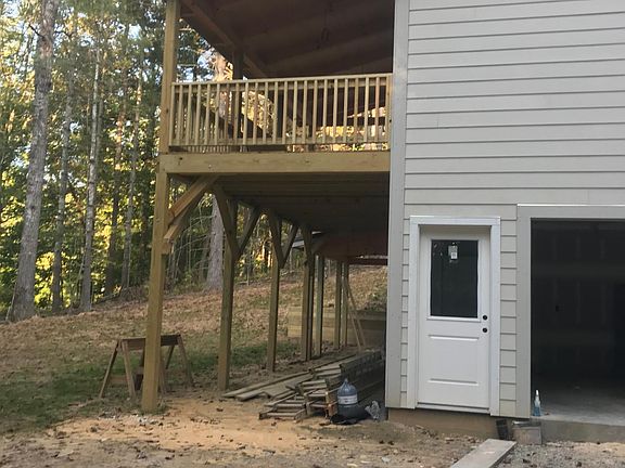 rear deck overlooks lake below 2 car garage