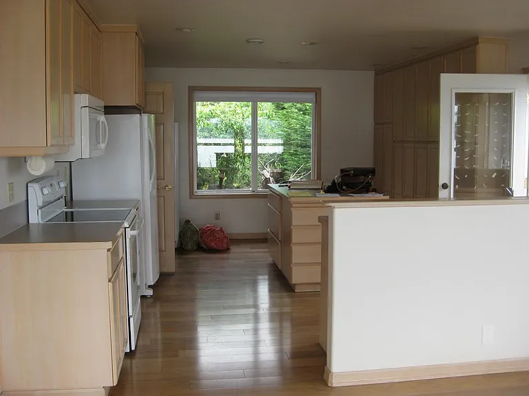 Large kitchen with wall of storage cabinets.