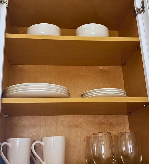 Tableware set including flat and deep plates, glass cups, and mugs.