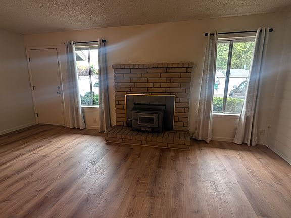 Nice sized living room with wood burning stove for cozy comfort in the winter.