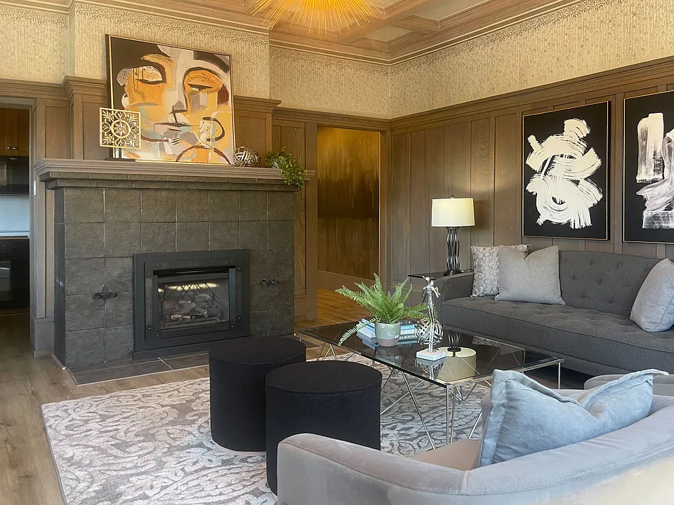 An example of how this spacious living room can be beautifully styled. The fireplace, rich wood details, and generous proportions create a naturally elegant, welcoming space with endless possibilities.