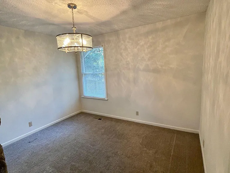 Another view of the dining area that shows the size of the area. There is also a window with a mini blind in this area to have just the right amount of natural light. You will notice on the front right side of the wall there is a cased opening that leads