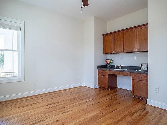 Main level office with built-in desk and cabinets