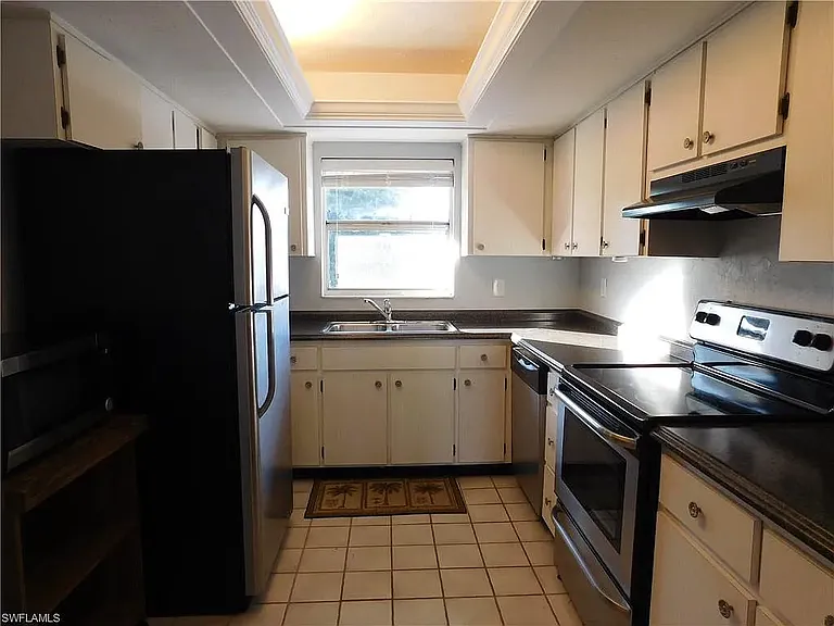 View of kitchen with better view of right side and appliances.
