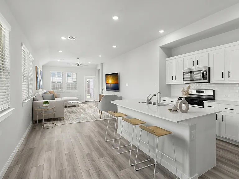 Virtually staged photo of the open concept living room and kitchen!