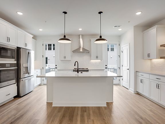 Kitchen with dual doors to deck for seamless indoor-outdoor living