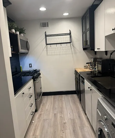 Galley kitchen with loads of storage.
