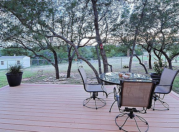 Composite decking and great Oak trees grace backyard.