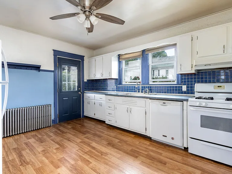 Exit out of kitchen to parking area and another outdoor living space.
Gas oven.