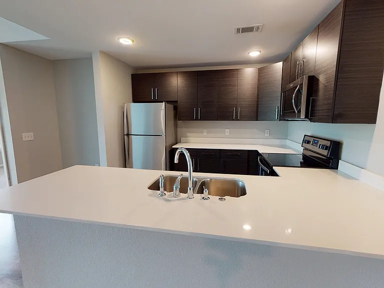 The Hawthorne kitchen includes quartz countertops and stainless steel appliances, including a glasstop electric stove, microwave, and dishwasher. The Hawthorne kitchen includes quartz countertops and stainless steel appliances, including a glasstop electr