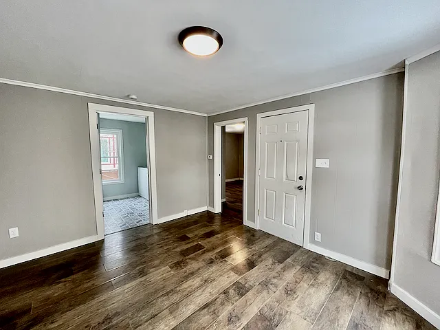 Living room with entry, bedroom, and bathroom/laundry off of it.