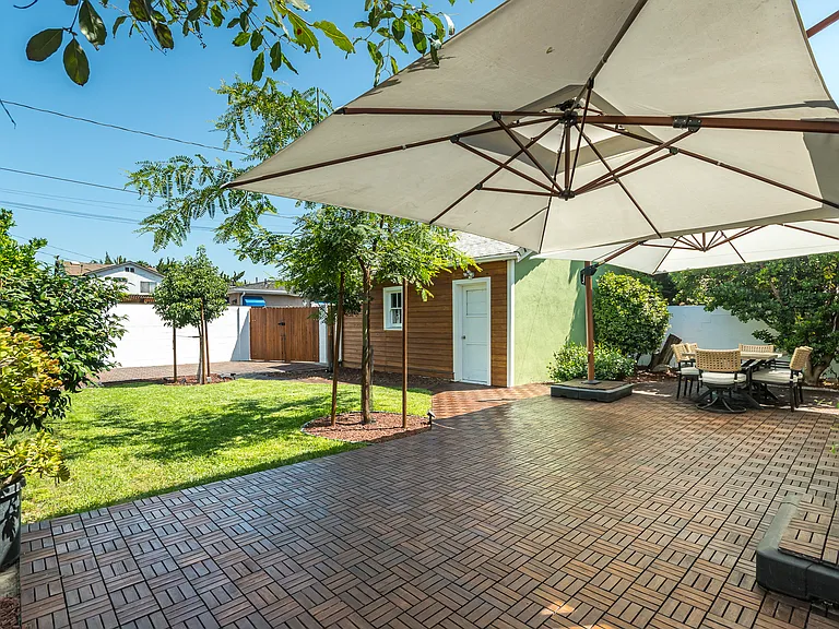 Private backyard retreat featuring a large patio for dining and entertaining, plus a lush lawn for play and relaxation.