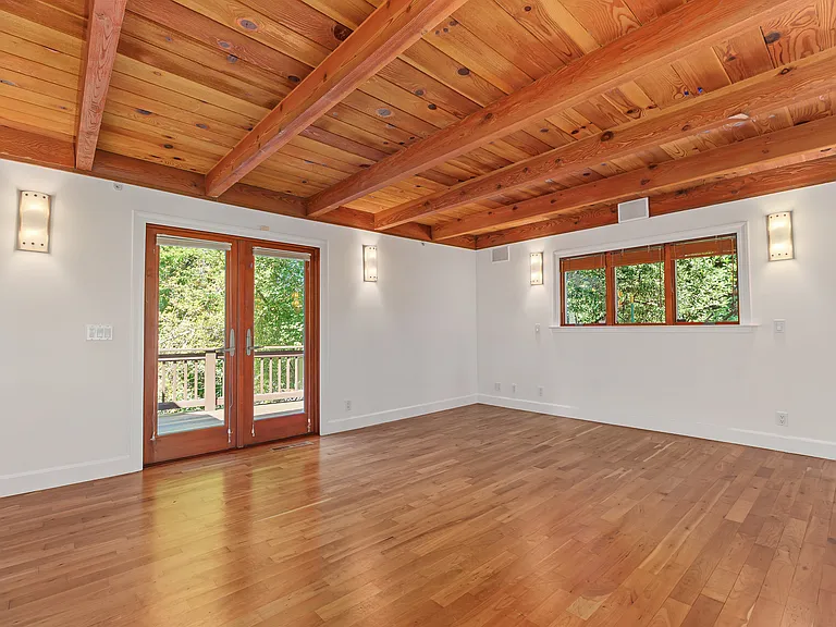 Master bedroom with direct access to deck, great for morning coffee in the sun.