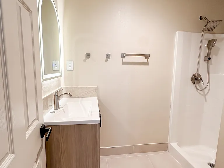 new bathroom tiles, vanity, toilet, sink, and more
