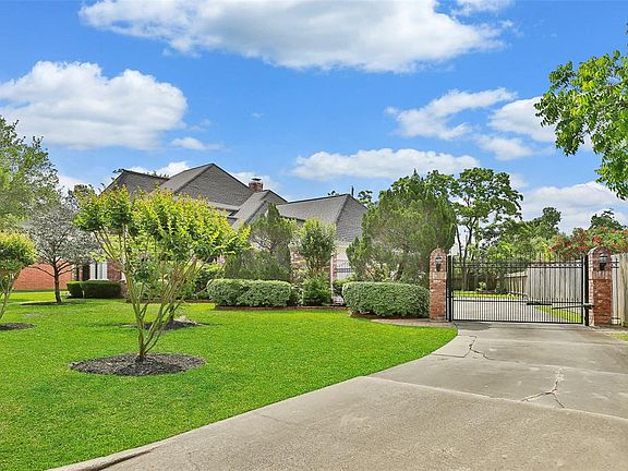 Long driveway with driveway gate. Beautiful large 13,668 s/f lot.