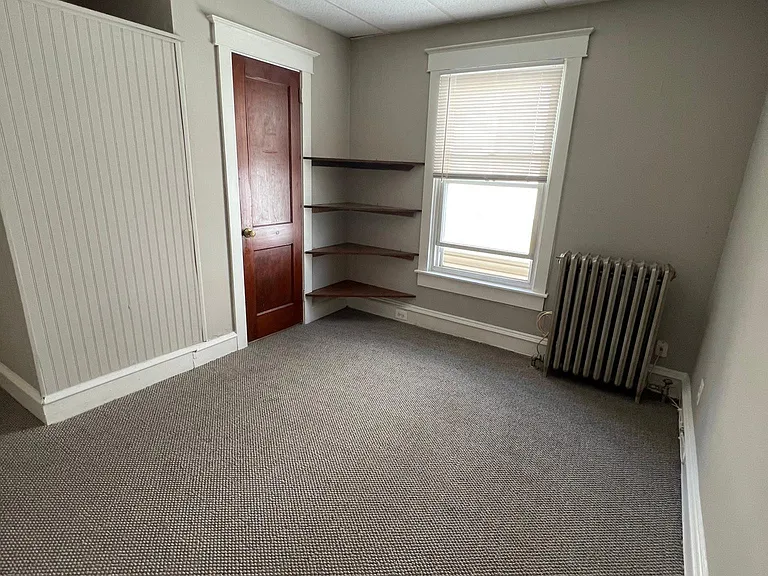 Living room showing door closed to bathroom