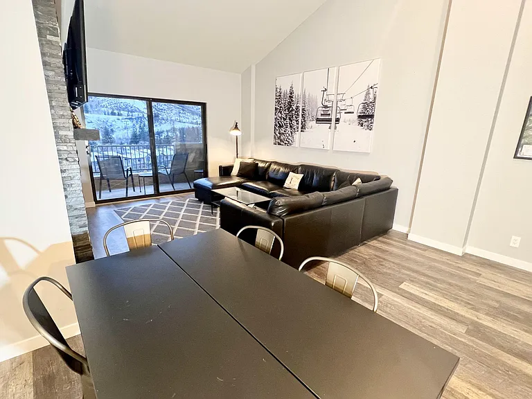 Living room with large sofa-bed sectional and storage chaise lounge, 65 in LED TV, fireplace, balcony with grill and sweeping views of Beaver Creek mountain