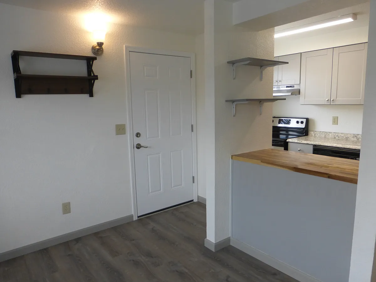 Larger view of front living room and kitchen. - 215 8th St SE #A
